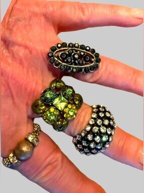 Collection of four adjustable band cocktail rings.